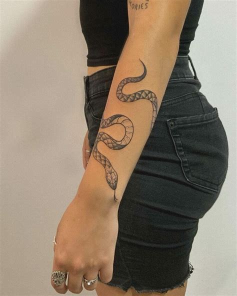 Snake wrapped around arm tattoo